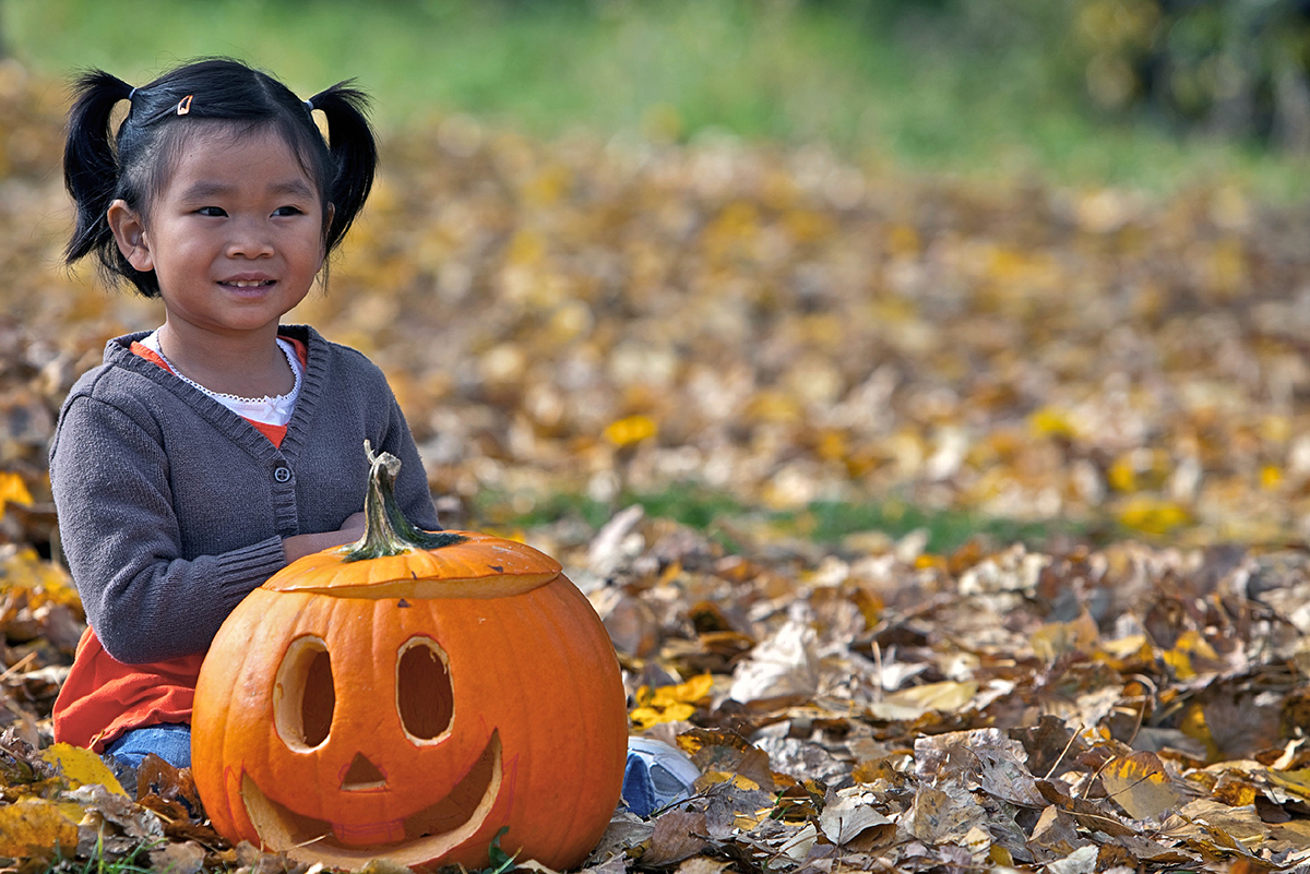 little girl with a pumpkin